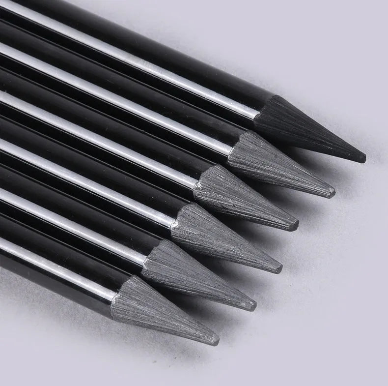 Set of six graphite pencils and three carbonized pencils with wooden shells on suction card packaging