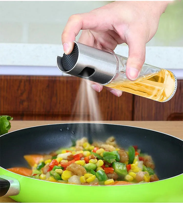 Gold push-type oil and vinegar spray bottle made of ABS plastic and glass with pump top.