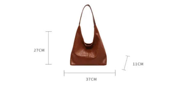 Casual soft PU leather shoulder bag in black with visible stitching and a front sandwich pocket.