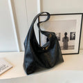 Casual soft PU leather shoulder bag in black with visible stitching and a front sandwich pocket.