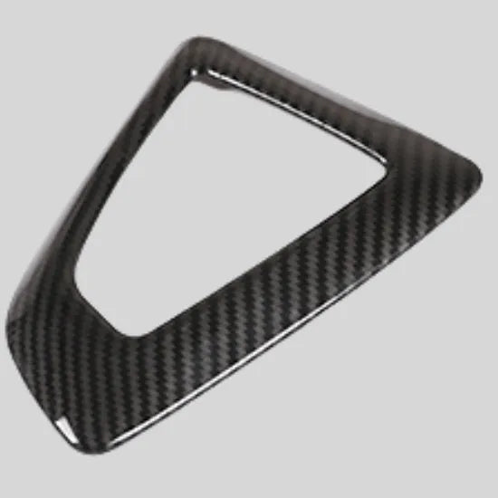 BMW gear base frame in left titanium colour with carbon fibre pattern, showing 3M adhesive backing.