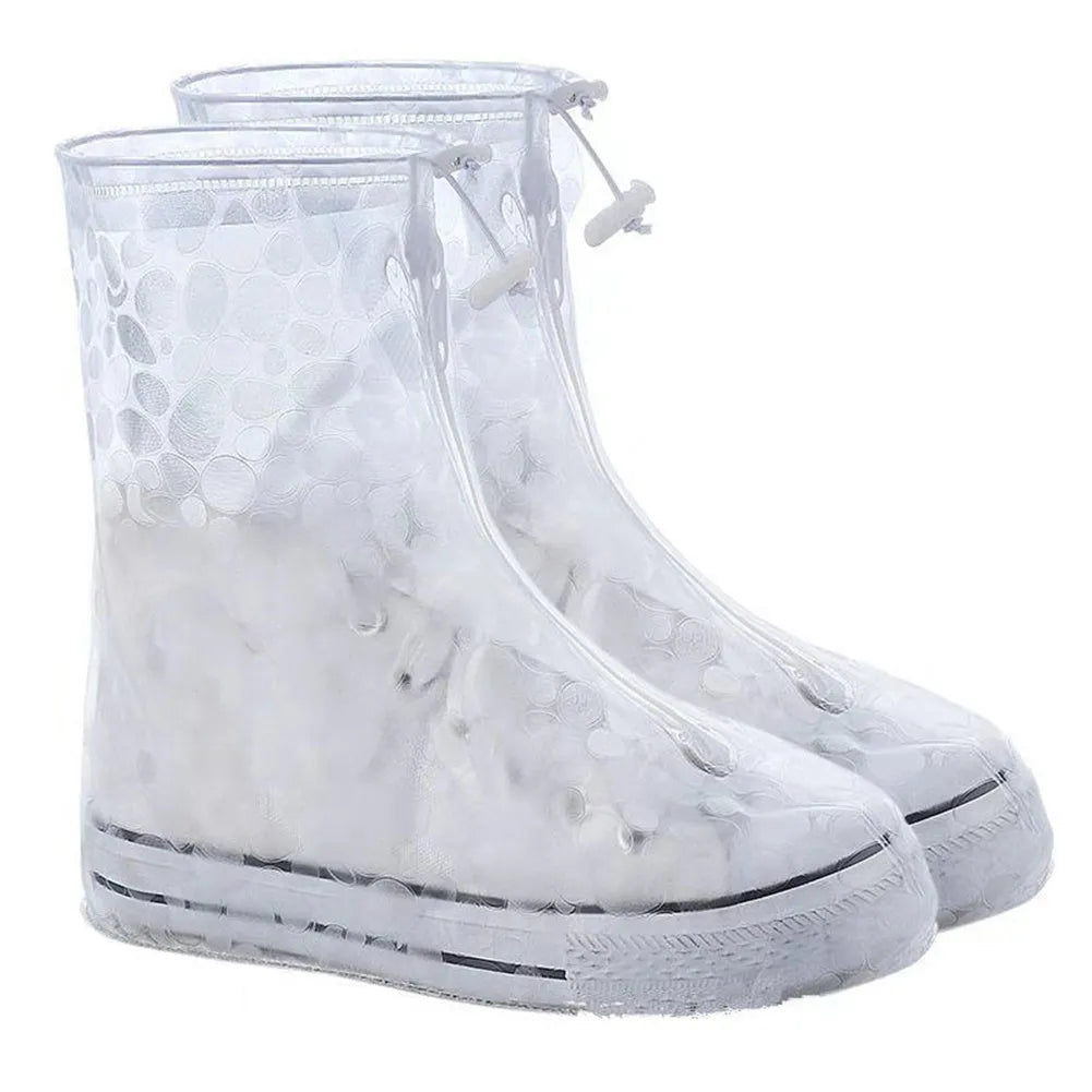 Waterproof PVC shoe covers in transparent dot white, non-slip sole, adult size, lying on a dry surface