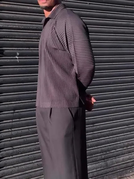 Men's black pleated long-sleeved casual top made from polyester, shown on a model.