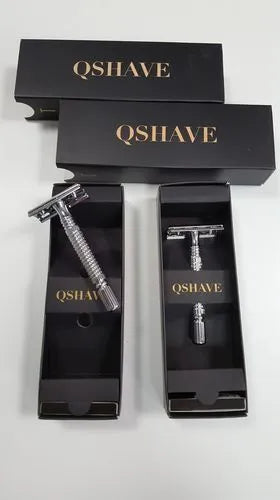 Chrome double edged safety razor with butterfly opening mechanism on a storage box