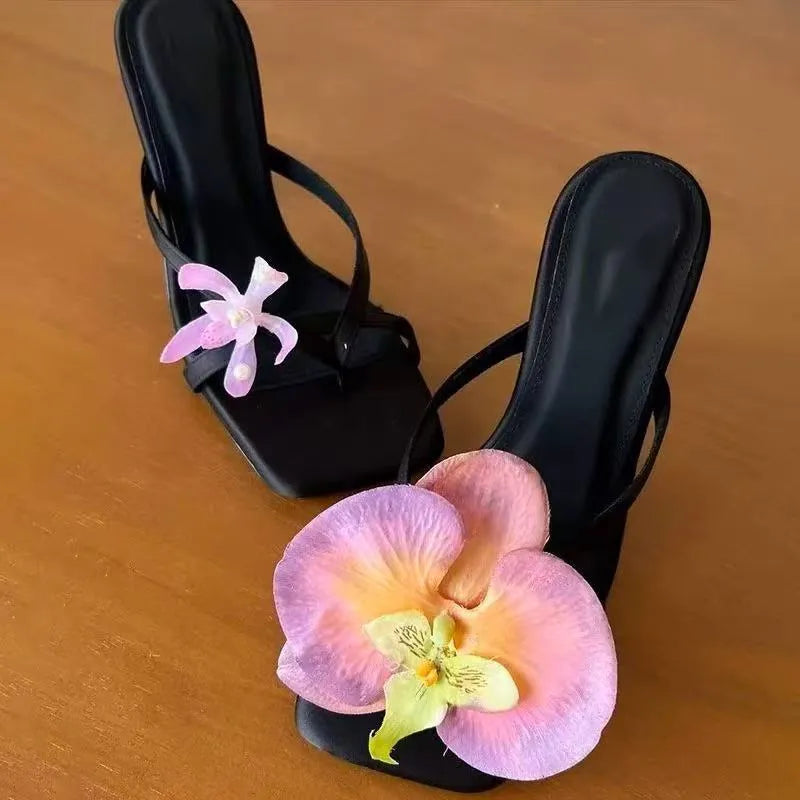 Women's handmade asymmetric floral high heel sandal in calf leather on a white background.