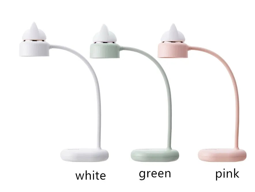 White clip-on LED desk lamp with touch controls and USB cable on a wooden desk.