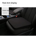 Black car seat cushion with dimensions 42x39x6cm on vehicle seat
