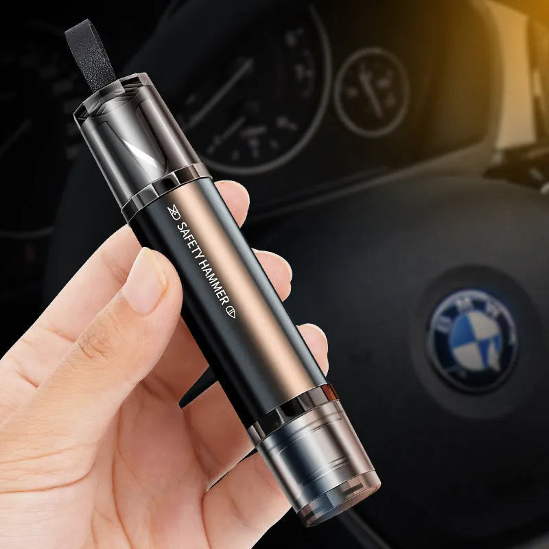 Black and red aluminium alloy car emergency hammer with tungsten steel tip and seat belt cutter on its mounting base.