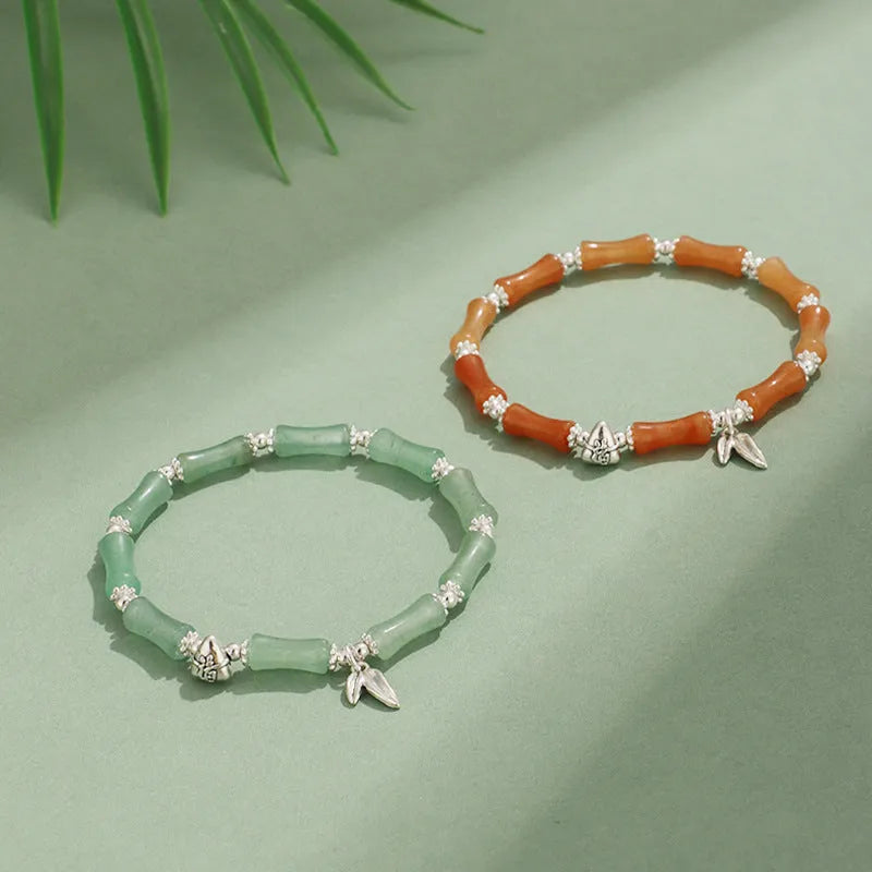 Green aventurine bamboo bead crystal bracelet with strawberry quartz and Dongling stones on wrist.