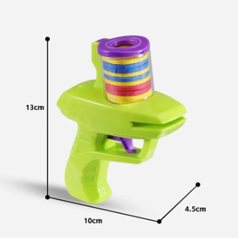 Green interactive cat toy launcher with foam disc on flat indoor surface.