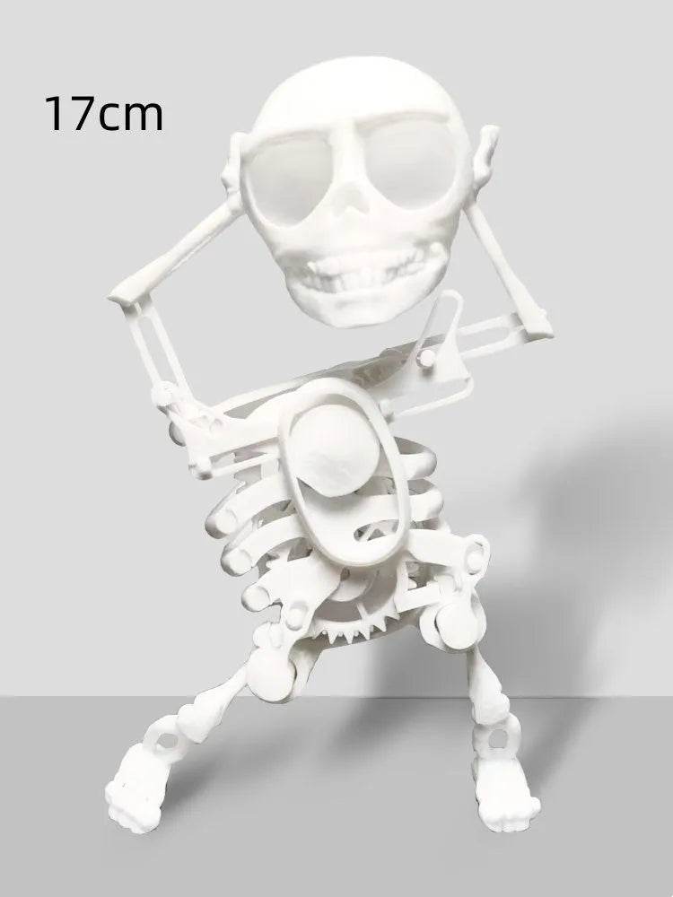 3D printed dancing skeleton gravity toy in pink and white, 22cm tall, on a desk