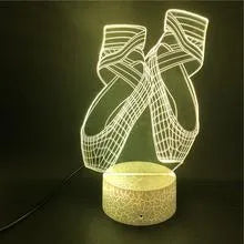 3D ballet dancer silhouette LED night light with remote control on a bedside table