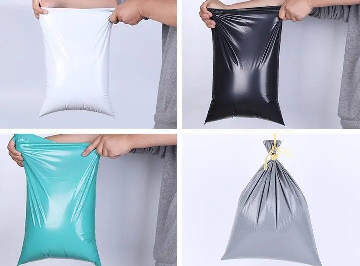 A bundle of 100 flat, clear PE plastic courier bags for clothing with adhesive sticker seals.