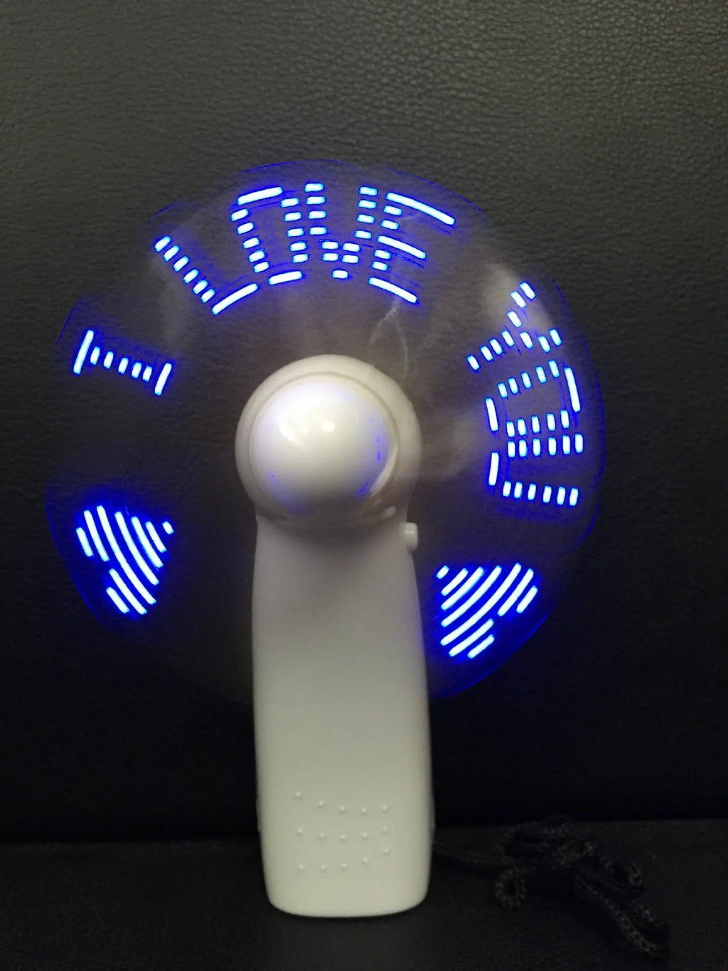 White handheld mini fan with blue and red LED flashing I love you pattern, showing dimensions.