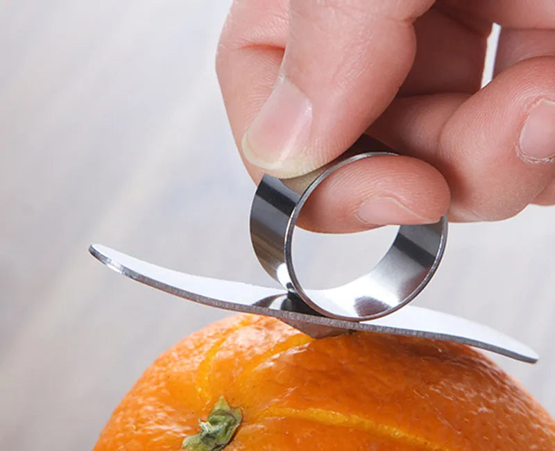 Silver stainless steel finger ring fruit peeler for citrus and pomegranates.