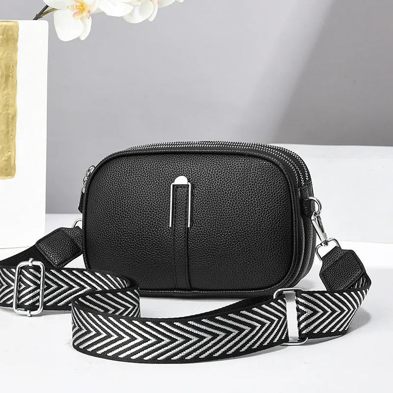 Soft PU leather women's oval crossbody bag showing slit pocket and internal organiser compartments