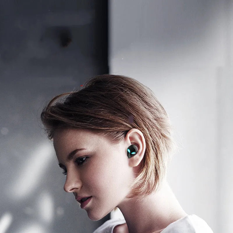 Creative Outer T8 Starman alien design Bluetooth headset with wireless charging case.