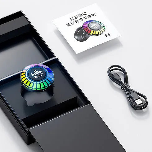 Small black cube voice control polar light Bluetooth LED atmosphere lamp on a table.