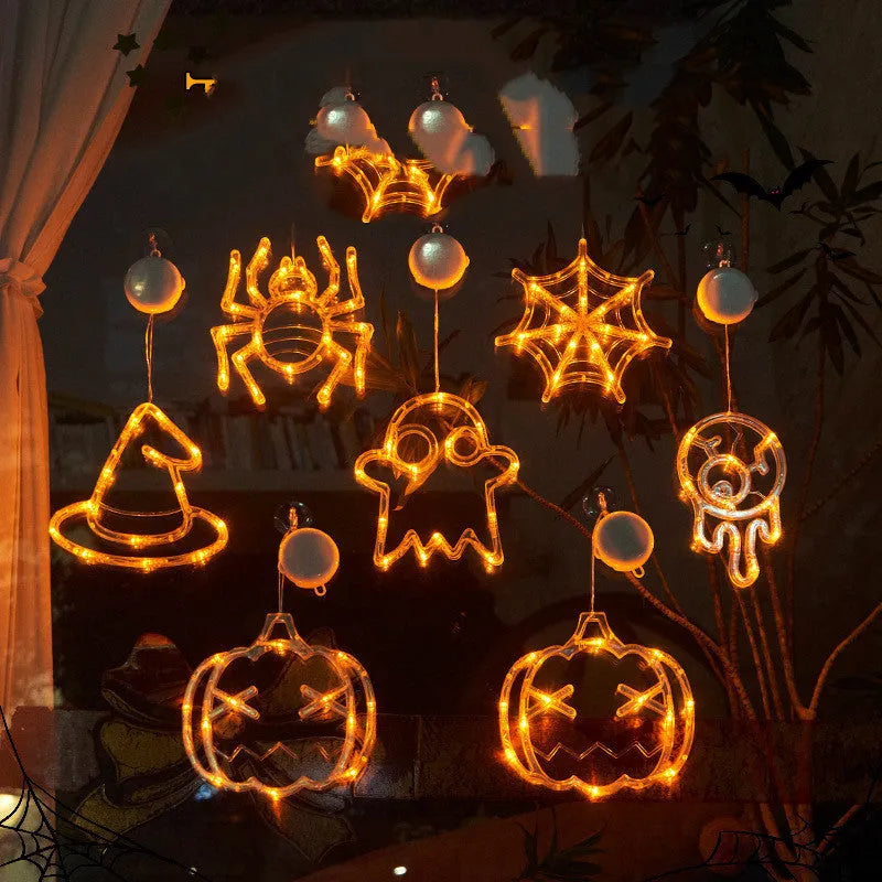 Halloween window hanging LED lights set with seven plastic decorations including spider, pumpkin, and ghost designs