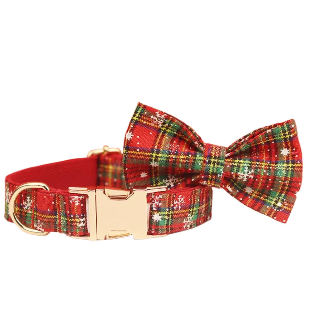 Red snowflake plaid fabric pet collar and leash set with matching dog vest and decorative bow.