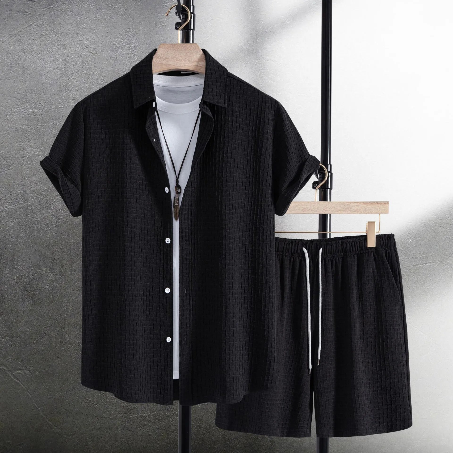 Men's casual short sleeve shirt and matching shorts set in black, laid flat.