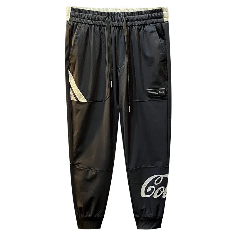 Man wearing solid black cropped cotton trousers with an ankle band.
