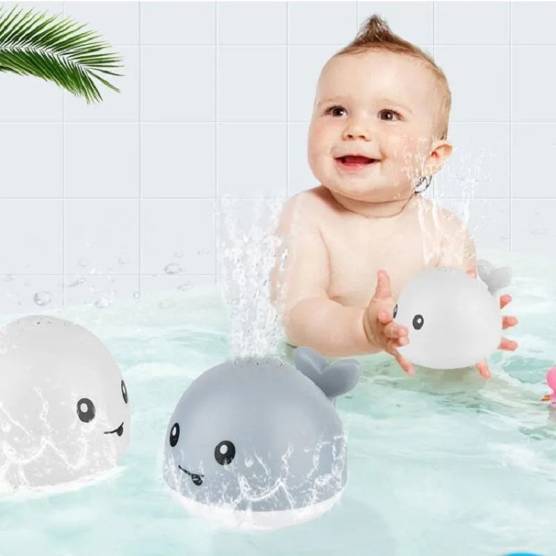 Whale-shaped electric bath toy with water spray, flashing lights, and automatic water sensing feature