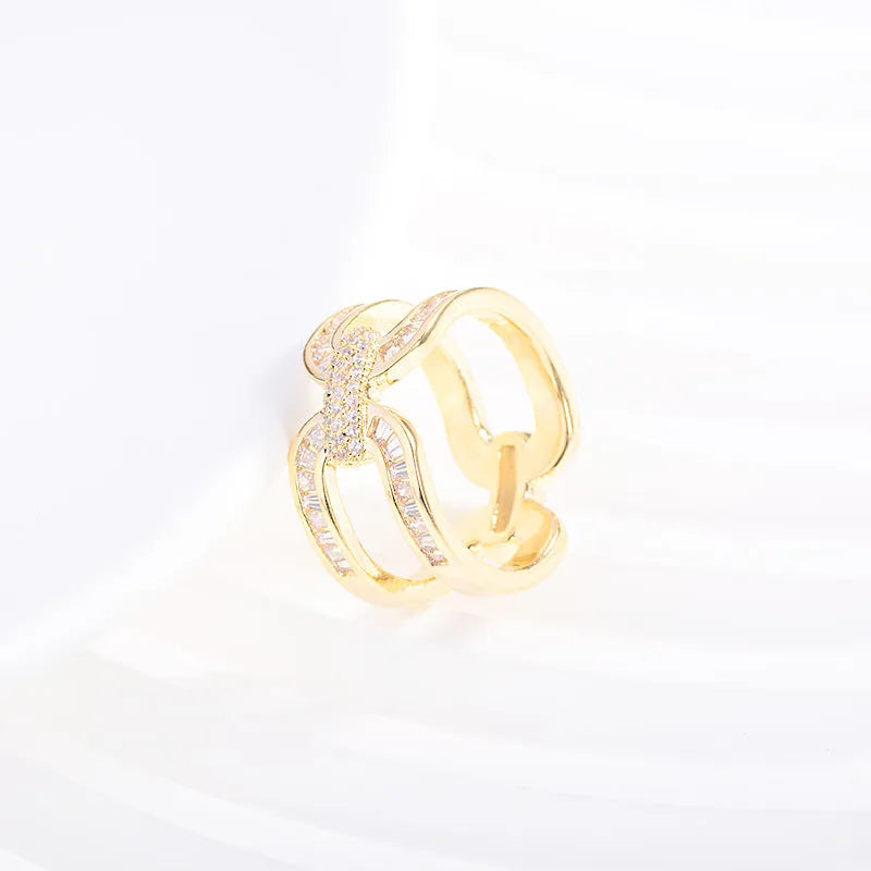 Round copper scarf ring with electroplated gold finish, geometric shape, on a silk scarf