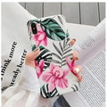 Pink floral TPU phone case for iPhone models on a table