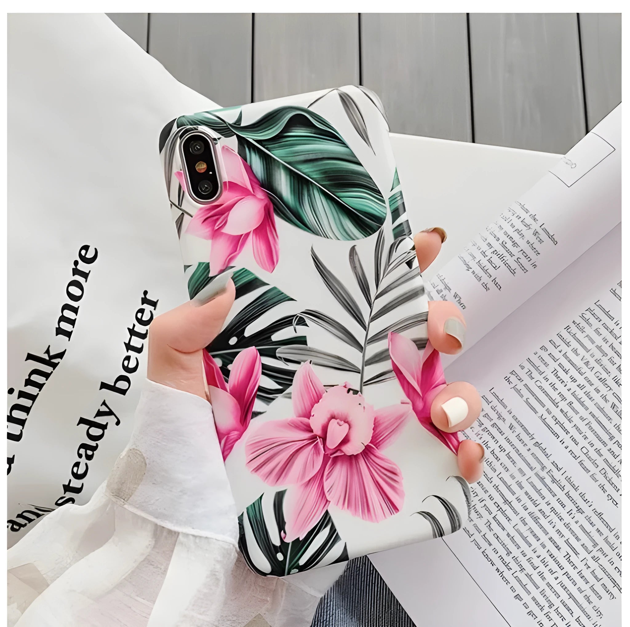 Pink floral TPU phone case for iPhone models on a table