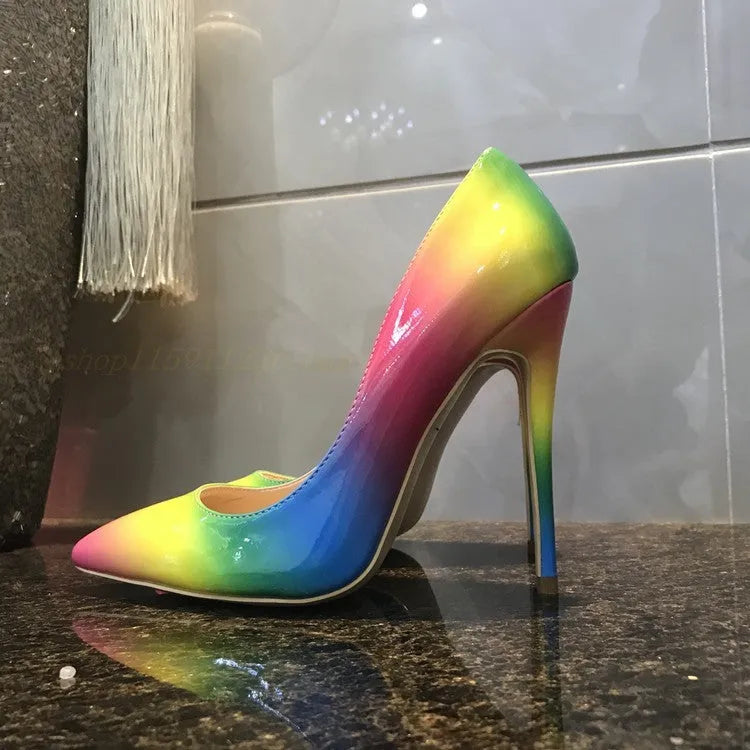 Rainbow coloured patent leather women's court shoes with a pointed toe and a thin ultra-high stiletto heel.