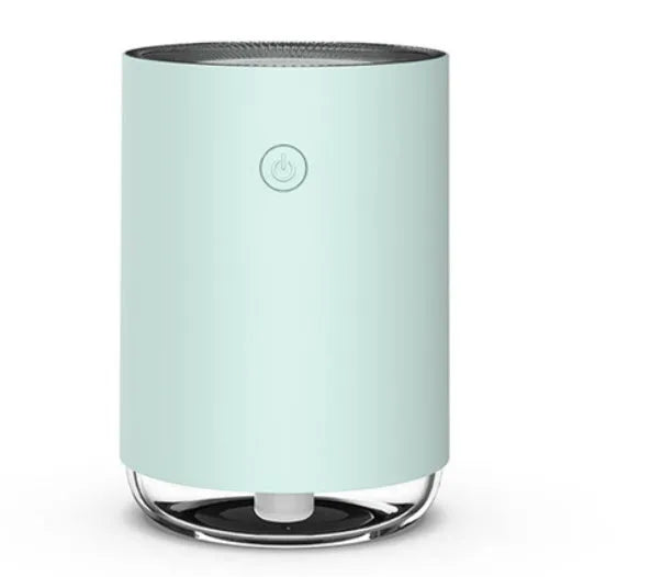 Green, pink, and white USB-powered humidifier diffuser with night light function on a wooden table.