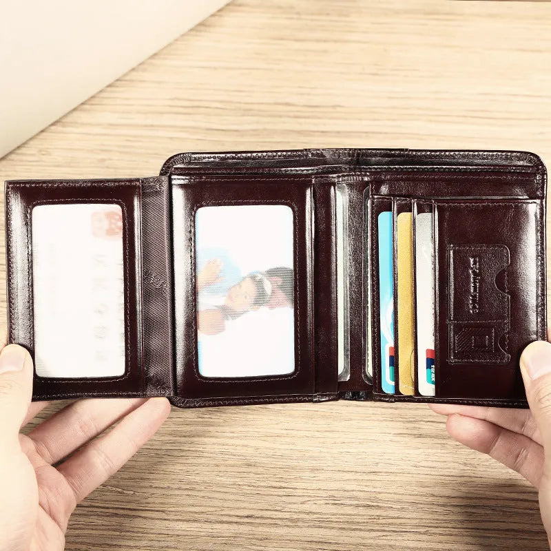 Men's black leather wallet open to show photo window, card slots, coin pocket and banknote folder.