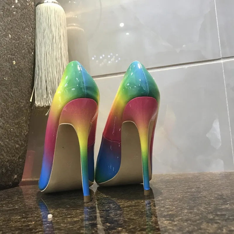 Rainbow coloured patent leather women's court shoes with a pointed toe and a thin ultra-high stiletto heel.