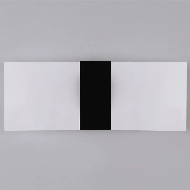 Black acrylic LED wall lamp with modern design mounted on wall