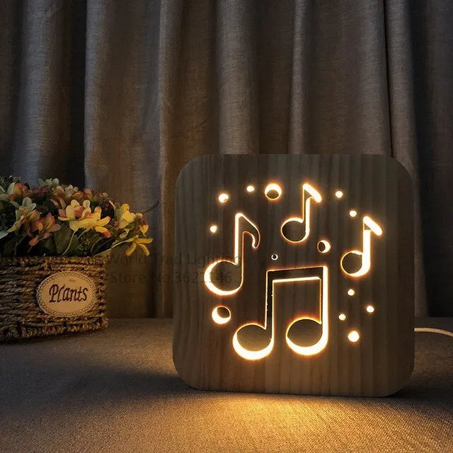 Natural pine wood cube LED atmosphere lamp with warm white glow on a desk.