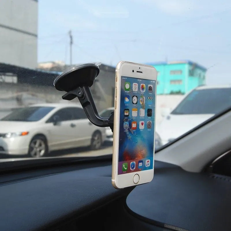 Black magnetic car phone holder with 360-degree rotating bracket mounted on dashboard
