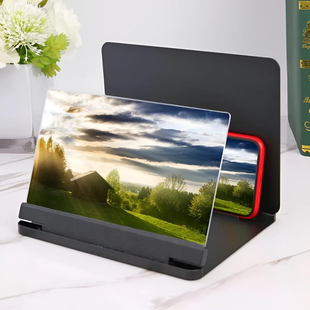White and black smartphone screen magnifier with integrated phone holder on a table.