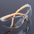 Transparent safety goggles with yellow tinted polycarbonate lenses for lab and welding protection.