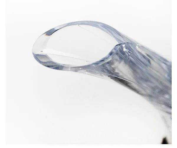 Clear acrylic wine aerator with stainless steel filter, shown next to a wine glass.