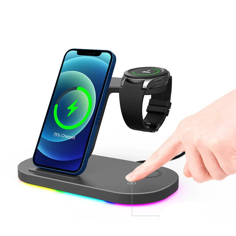 Three-in-one wireless charging station in black, charging a mobile phone, a smartwatch, and wireless headphones.