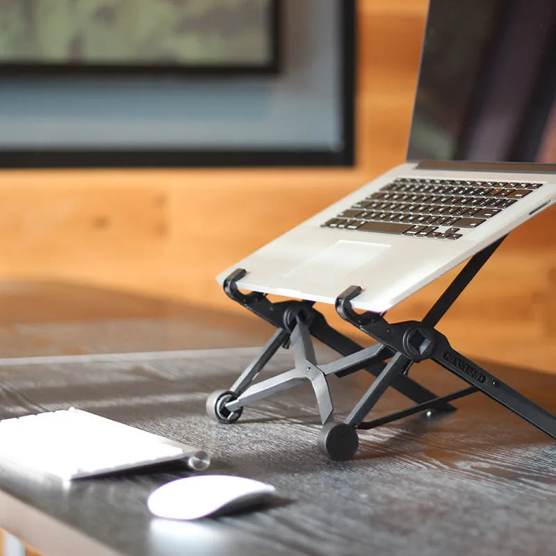 Black folding laptop stand showing folded and unfolded positions with reinforced nylon construction