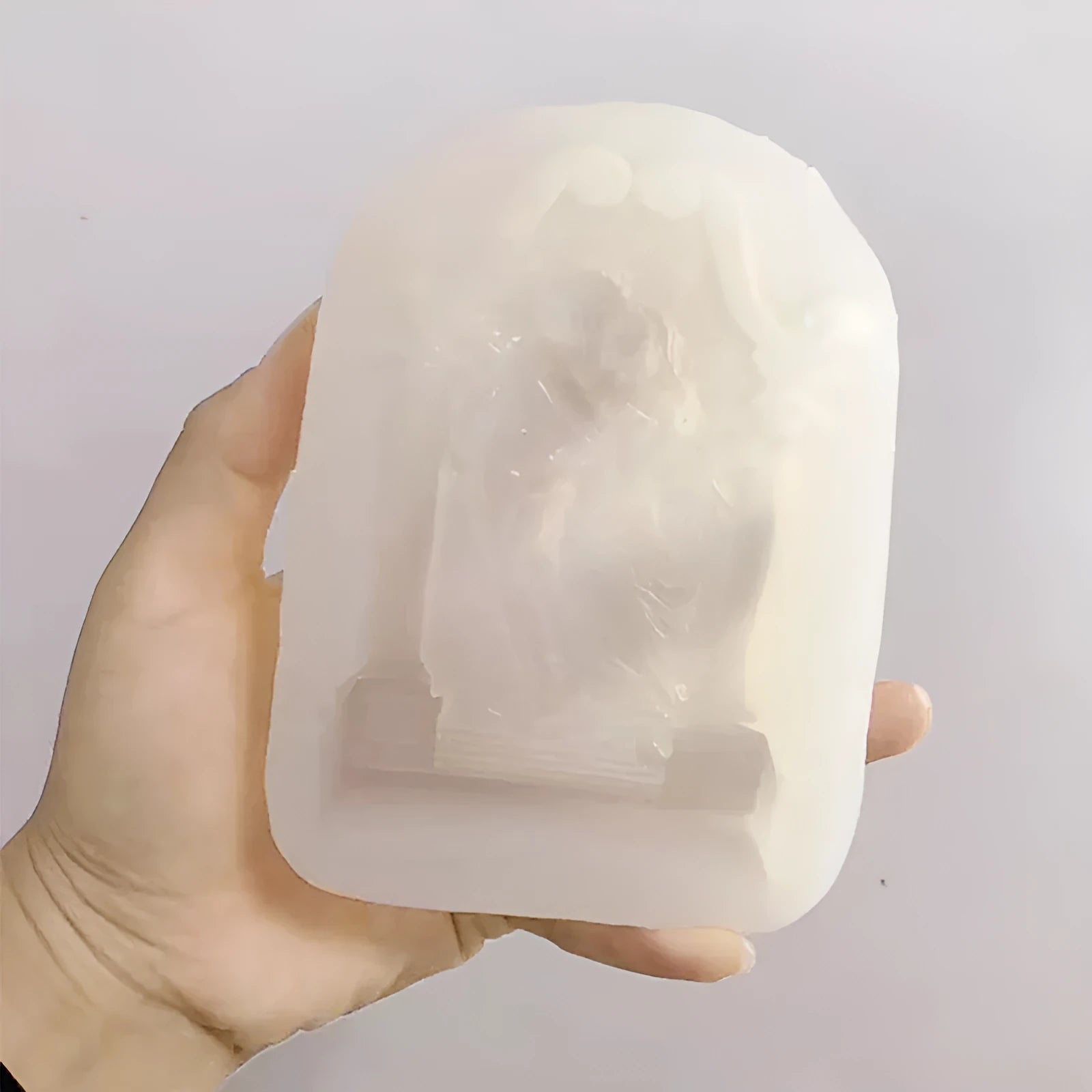 Food-grade silicone mould showing detailed Ancient Greek couple angel design for baking and crafts.