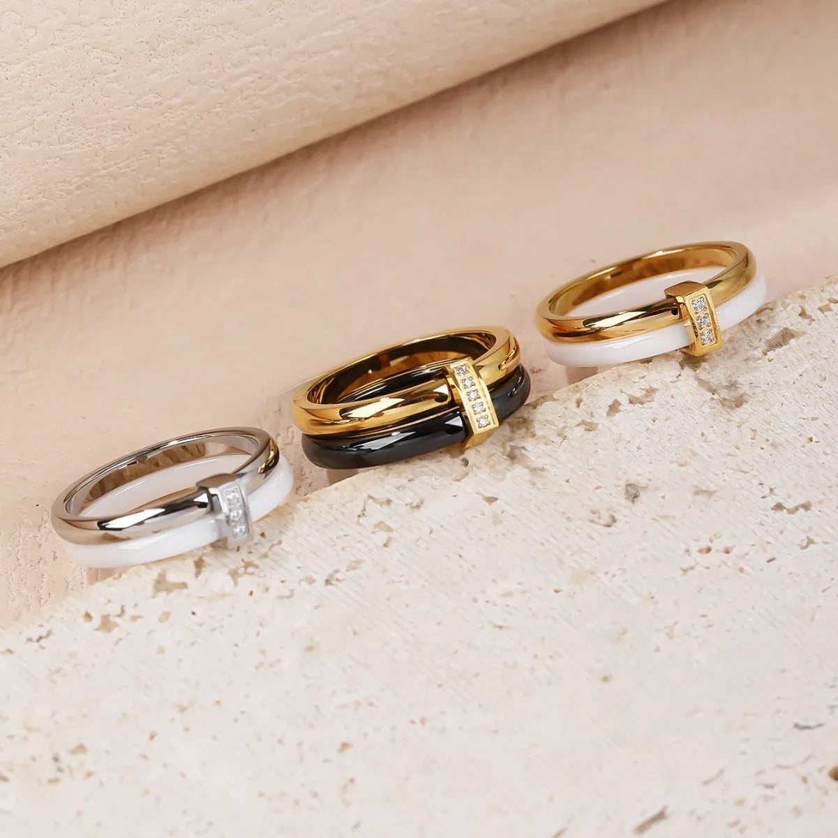 Glossy titanium steel women's ring with zirconium inlay in a heart shape on a double band.