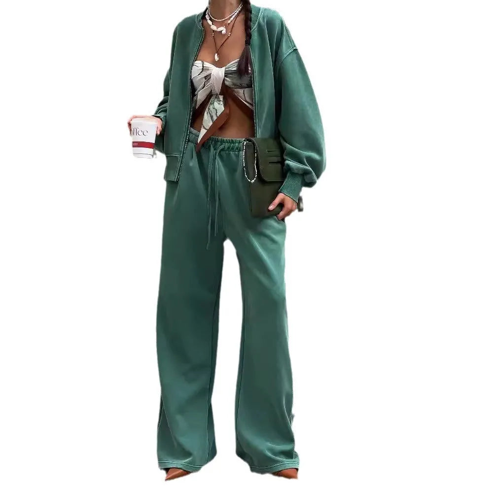 Women's green thermal sweater with front zip and stand collar, paired with matching trousers, on a white background