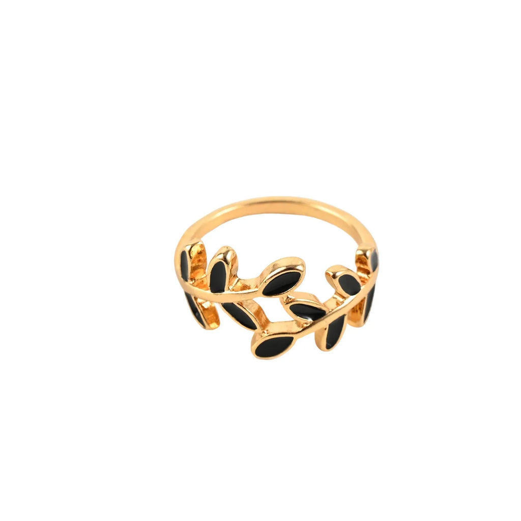 Gold geometric leaf acrylic ring for women on an index finger.