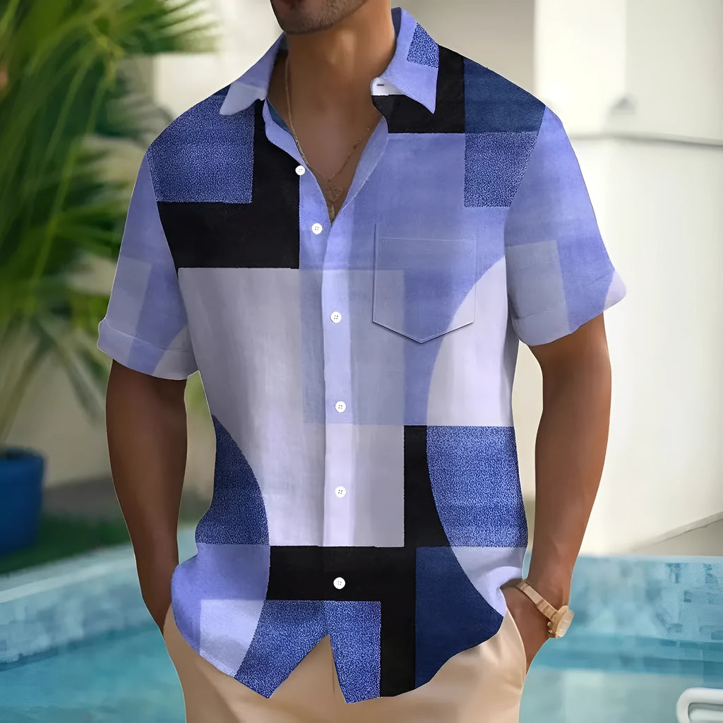 Man wearing a loose-fit cardigan shirt with a retro geometric square print in contrasting colours.