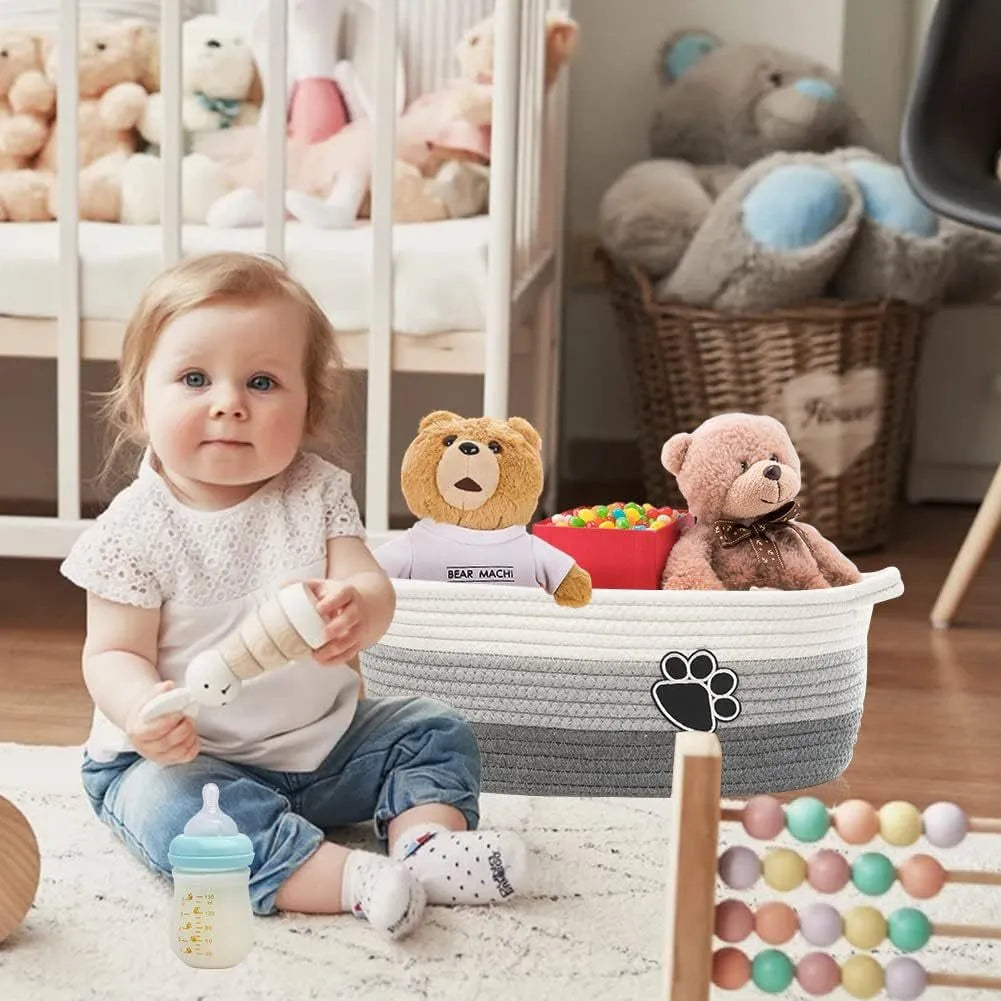 Small light beige woven cotton rope storage basket with a wooden handle.