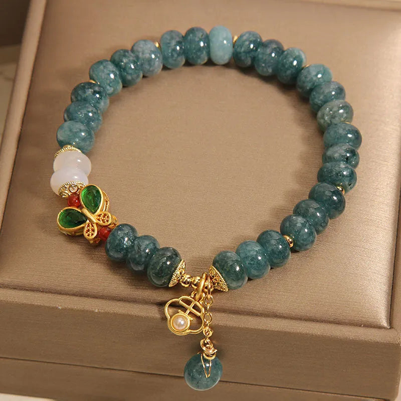 Women's blue water jade abacus bead bracelet with alloy inlay and white agate accents