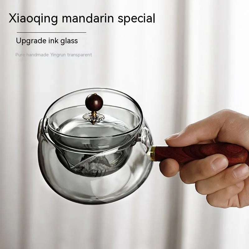 Transparent borosilicate glass teapot with wooden handle and rotation mechanism